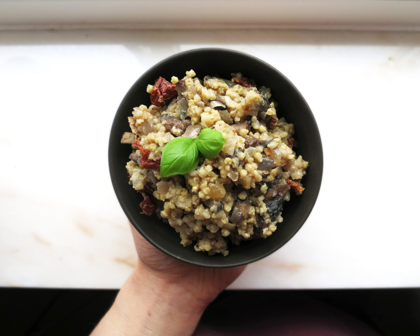 Authentic millet risotto with mushrooms and sun-dried tomatoes